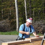 A man working on a wooden board with some wood.